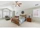 Bright bedroom featuring a ceiling fan, vaulted ceiling, comfortable seating area, and neutral decor at 15407 E Crestline Pl, Centennial, CO 80015