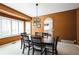 Elegant dining room with modern chandelier, rich wood table, and plentiful natural light from bright windows at 15407 E Crestline Pl, Centennial, CO 80015