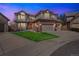 Attractive two-story home featuring a brick facade, dormer windows, and a two-car garage at 15407 E Crestline Pl, Centennial, CO 80015