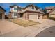 Attractive two-story home with brick and siding, a three-car garage, and well-maintained landscaping at 15407 E Crestline Pl, Centennial, CO 80015