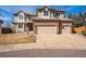 Charming two-story home featuring a brick facade, dormer windows, and a two-car garage at 15407 E Crestline Pl, Centennial, CO 80015
