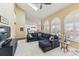 Bright living room featuring high ceilings, large arched windows, and a comfortable sectional sofa with stylish decor at 15407 E Crestline Pl, Centennial, CO 80015