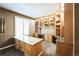 Well-appointed home office featuring custom built-in shelving, a large desk, and natural light from the window at 15407 E Crestline Pl, Centennial, CO 80015