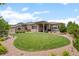Lush backyard features a covered patio, lush grass, and manicured landscaping at 17358 W 95Th Ave, Arvada, CO 80007