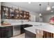 Bar area with overhead lighting, shelving, custom wood work, and island seating at 17358 W 95Th Ave, Arvada, CO 80007