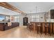 Finished basement featuring a bar with seating, lounge area, and wood-style flooring at 17358 W 95Th Ave, Arvada, CO 80007
