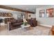 Basement living area with a couch, bar, television, and structural wood beam at 17358 W 95Th Ave, Arvada, CO 80007