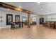 Finished basement with wood floors, structural beam, bar, dining, and lounge area at 17358 W 95Th Ave, Arvada, CO 80007