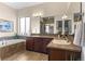 Well-appointed bathroom featuring double sinks, a large mirror, and a soaking tub for relaxation at 17358 W 95Th Ave, Arvada, CO 80007