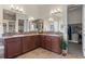 Luxurious bathroom with double sinks, granite countertops, and a seamless glass shower offering style and functionality at 17358 W 95Th Ave, Arvada, CO 80007