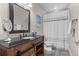 Nicely decorated bathroom features a modern vanity with barn door style lower cabinet at 17358 W 95Th Ave, Arvada, CO 80007