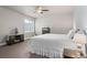 Bedroom with carpet, a ceiling fan, a window, and a bed with white bedding at 17358 W 95Th Ave, Arvada, CO 80007
