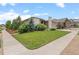 Well-manicured lawn and mature trees enhance this home's curb appeal at 17358 W 95Th Ave, Arvada, CO 80007