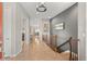 Hallway with wood floors, wooden railing, art on the wall, and an open floor plan at 17358 W 95Th Ave, Arvada, CO 80007