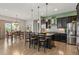 Spacious kitchen with dark cabinets, granite countertops, stainless steel appliances, and a dining area at 17358 W 95Th Ave, Arvada, CO 80007