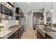 Modern kitchen featuring stainless steel appliances, dark cabinetry, granite countertops, and a stylish island at 17358 W 95Th Ave, Arvada, CO 80007