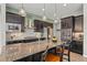 Modern kitchen featuring a granite island, stainless steel appliances, and stylish pendant lighting at 17358 W 95Th Ave, Arvada, CO 80007