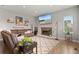 Cozy living room featuring a stone fireplace, plush seating, and stylish decor, perfect for relaxation at 17358 W 95Th Ave, Arvada, CO 80007