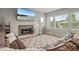 Comfortable living room with a stone fireplace, large windows, and plush seating, great for Gathering gatherings at 17358 W 95Th Ave, Arvada, CO 80007