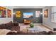 Modern living room with a comfortable couch, mounted TV, and natural light from the window at 17358 W 95Th Ave, Arvada, CO 80007