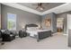 Serene main bedroom with a chair, trey ceiling, and ensuite bathroom creating a private oasis at 17358 W 95Th Ave, Arvada, CO 80007