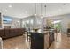 Bright and airy open floorplan with a modern kitchen, dining area, and living room, perfect for entertaining at 17358 W 95Th Ave, Arvada, CO 80007