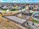 Scenic aerial view showcasing a home with a fenced backyard, complemented by the surrounding neighborhood and distant mountains at 11950 Mosey Ct, Parker, CO 80138
