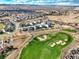 Expansive aerial view of a residential community next to a golf course with mountain views at 11950 Mosey Ct, Parker, CO 80138