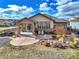 Landscaped backyard with patio and chairs, with mature trees and plants, of a single Gathering home at 11950 Mosey Ct, Parker, CO 80138