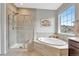 Bathroom featuring a soaking tub, tiled shower, and picture window at 11950 Mosey Ct, Parker, CO 80138