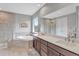 Bathroom with double vanity, soaking tub, and walk-in shower with glass door at 11950 Mosey Ct, Parker, CO 80138