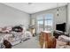 Cluttered bedroom with floral bedding, a ceiling fan, and a large window, showcasing a lived-in space with personal touches at 11950 Mosey Ct, Parker, CO 80138