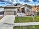 Charming two-story home with stone accents, a three-car garage, and a well-maintained lawn at 11950 Mosey Ct, Parker, CO 80138