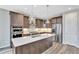 Modern kitchen featuring stainless steel appliances, quartz countertops, and ample cabinet space at 11950 Mosey Ct, Parker, CO 80138