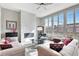 A living room featuring a fireplace, hardwood flooring, modern furniture and lots of natural light at 11950 Mosey Ct, Parker, CO 80138