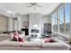Bright living room with a modern fireplace, sleek furnishings, and large windows offering plenty of natural light at 11950 Mosey Ct, Parker, CO 80138