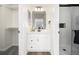 Bathroom with single vanity, modern fixtures, a medicine cabinet and a shower at 7543 Eaton St, Arvada, CO 80003