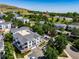 Community aerial showcasing building layout and surroundings with mature trees and nearby town features at 1697 S Cole St # B5, Lakewood, CO 80228