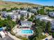 Aerial view showing community pool, hot tub, and multiple residences at 1697 S Cole St # B5, Lakewood, CO 80228