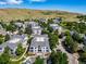 Extensive aerial view of homes amidst mature trees and landscaping under a bright sky at 1697 S Cole St # B5, Lakewood, CO 80228