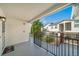 Spacious balcony featuring black metal railings and partial views of neighboring buildings and lush greenery at 1697 S Cole St # B5, Lakewood, CO 80228
