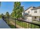 Picturesque view from the balcony overlooking well-maintained lawns, mature trees, and neighboring townhouse units at 1697 S Cole St # B5, Lakewood, CO 80228