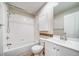 Bathroom features a shower/tub combo, white cabinetry, and decorative backsplash at 1697 S Cole St # B5, Lakewood, CO 80228