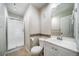 Neutral bathroom featuring tile flooring, shower with glass door, toilet, and vanity at 1697 S Cole St # B5, Lakewood, CO 80228