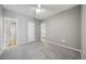 A large bedroom features neutral paint and carpet, a ceiling fan, and multiple doorways at 1697 S Cole St # B5, Lakewood, CO 80228