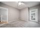 This bedroom has neutral paint, carpet, a ceiling fan, and a door to the outside at 1697 S Cole St # B5, Lakewood, CO 80228
