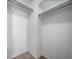 Walk-in closet features white walls, carpeted floors, and shelving at 1697 S Cole St # B5, Lakewood, CO 80228