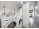 Laundry room with washer, dryer, and shelving at 1697 S Cole St # B5, Lakewood, CO 80228