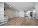 Inviting living room featuring wood floors and an open layout next to a modern kitchen at 1697 S Cole St # B5, Lakewood, CO 80228