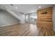 Open-concept living room with staircase and wood accent wall at 1697 S Cole St # B5, Lakewood, CO 80228